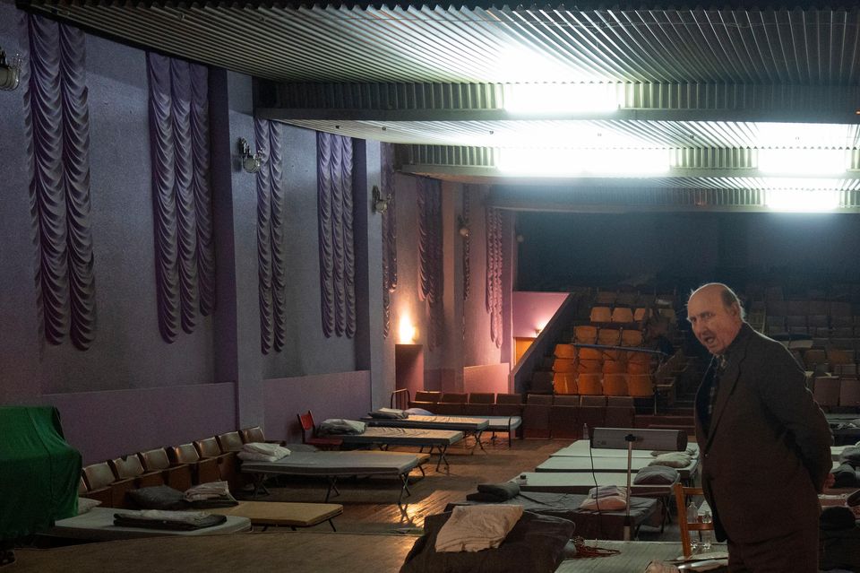 A man waits for evacuation to western Ukraine as he stands by a bed in a city theatre that hosts refugees fleeing from the Russian offensive in the Donetsk region (Efrem Lukatsky/AP)