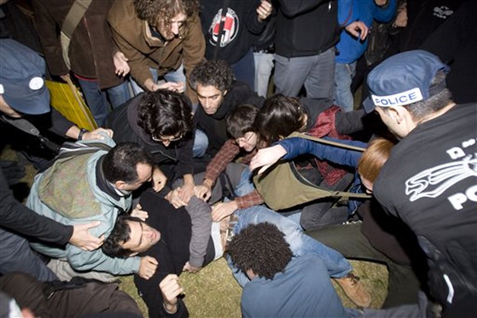 Israeli police officers scuffle with Israeli left wing activists during a protest against the Israeli strikes on the Gaza Strip, in Tel Aviv, Israel, Saturday, Dec. 27, 2008. Israeli warplanes retaliating for rocket fire from the Gaza Strip pounded dozens of security compounds across the Hamas-ruled territory in unprecedented waves of airstrikes Saturday, killing more than 200 people and wounding nearly 400 in the single bloodiest day of fighting in years. (AP Photo/Ariel Schalit)