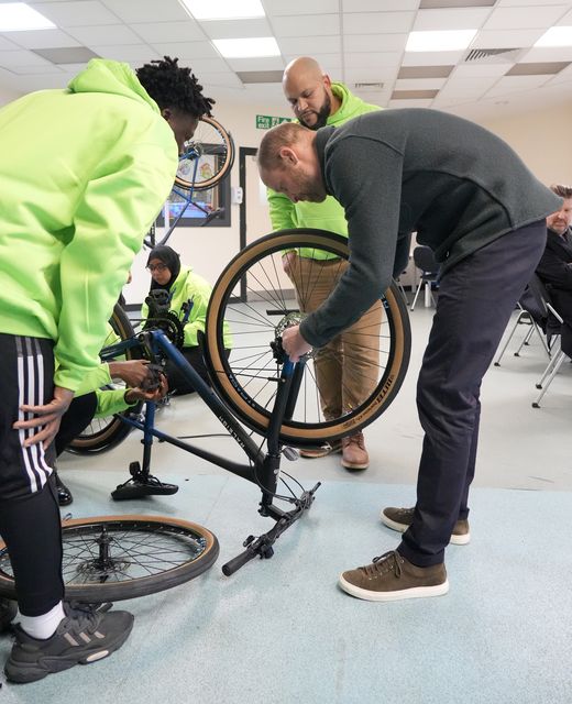 The Prince of Wales worked on a bike (Dominic Lipinski/PA)