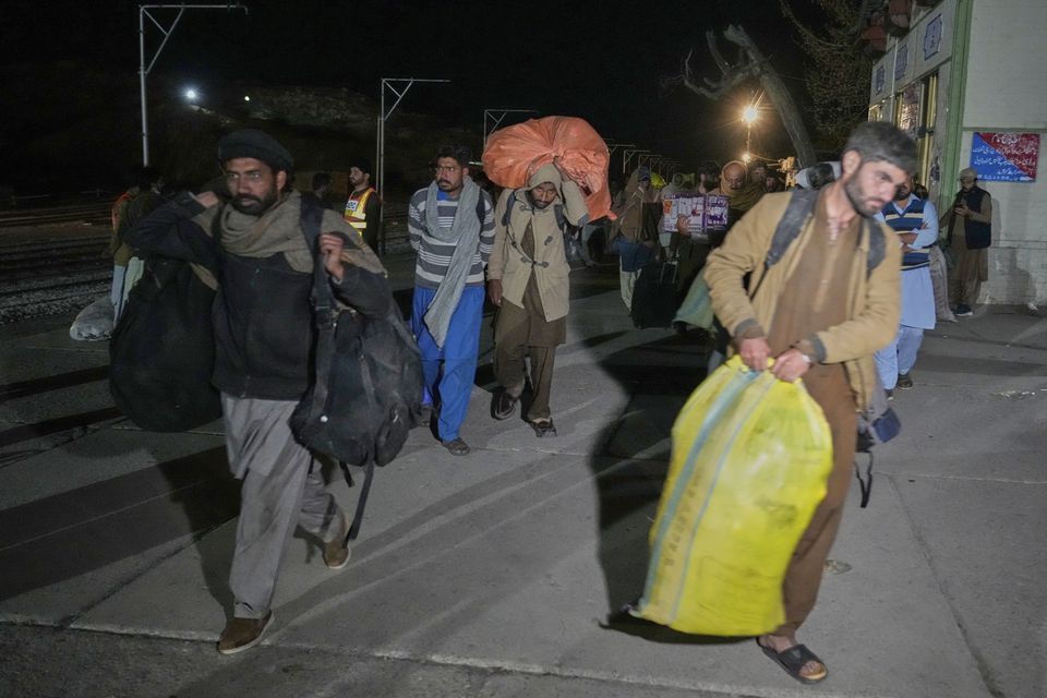 Rescued passengers arrived at Much railway station in Balochistan province on Thursday (Anjum Naveed/AP)