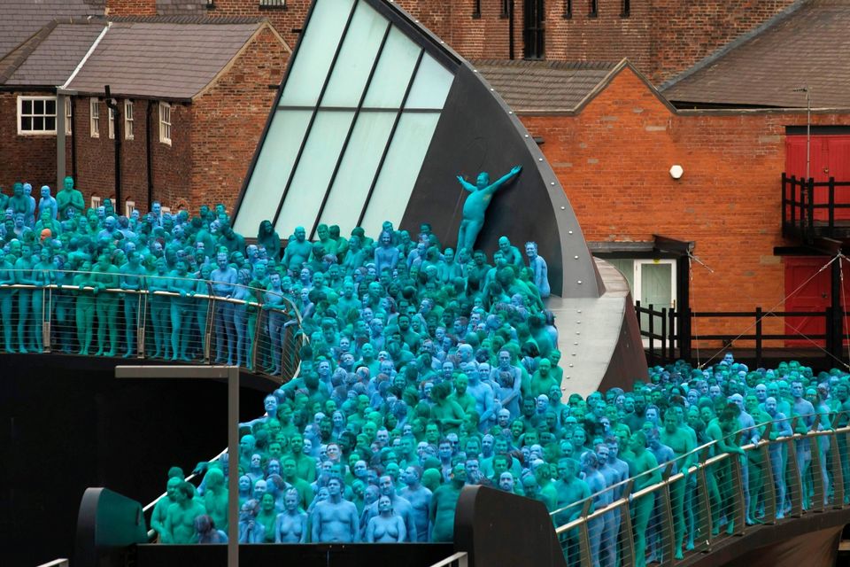Naked volunteers, painted in blue to reflect the colours found in Marine paintings in Hull's Ferens Art Gallery, are seen participating in US artist, Spencer Tunick's "Sea of Hull" installation on the Scale Lane swing bridge in Kingston upon Hull on July 9, 2016. AFP/Getty Images