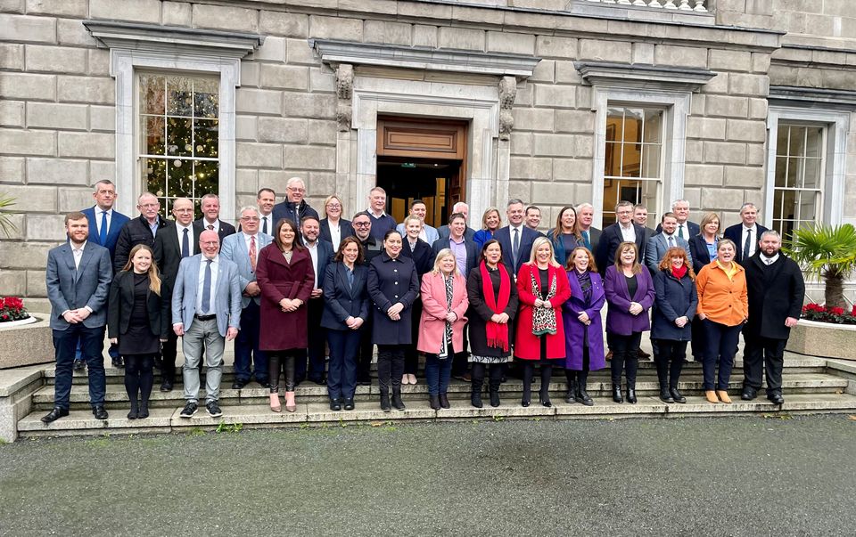 Mary Lou McDonald and Michelle O’Neill with Sinn Fein’s team of TDs outside Leinster House in Dublin on Wednesday (PA)