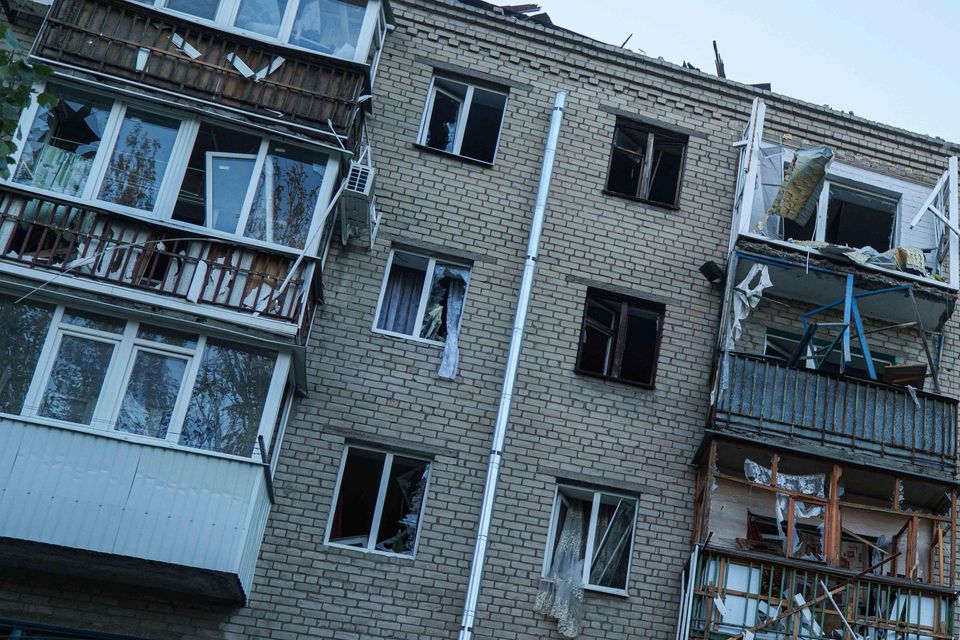 People clear the rubble in a front of a residential building heavily damaged in a Russian air strike in Kramatorsk, Donetsk region, Ukraine (Evgeniy Maloletka/AP)