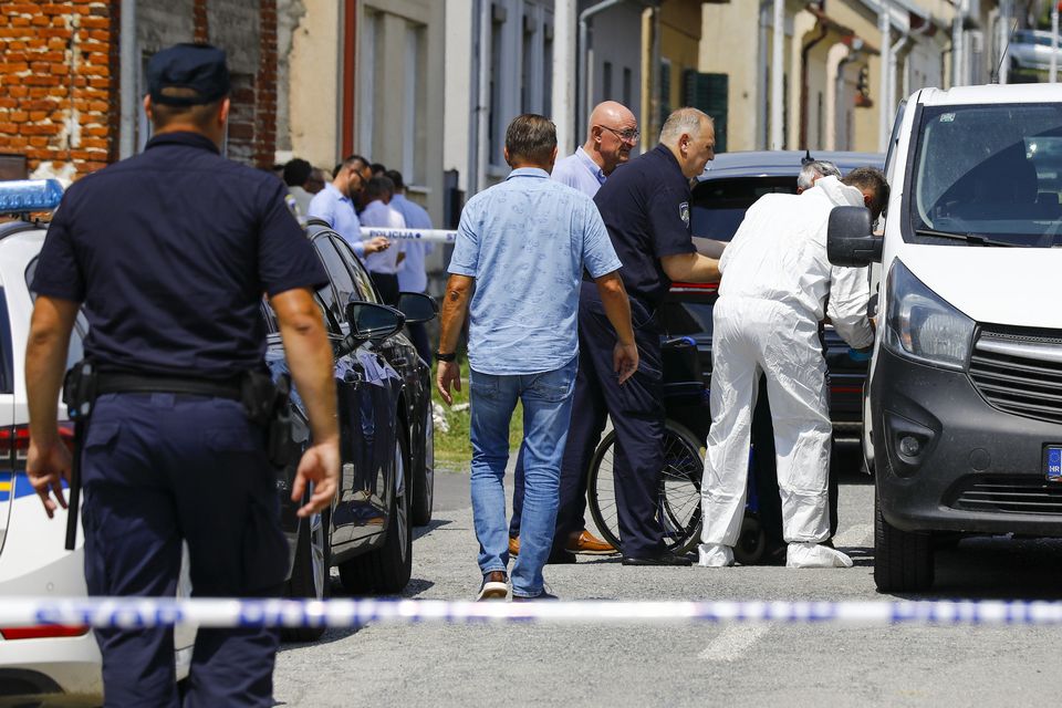 Police and forensic officers gather near the crime scene in Daruvar (Zeljko Puhovski/Cropix/AP)