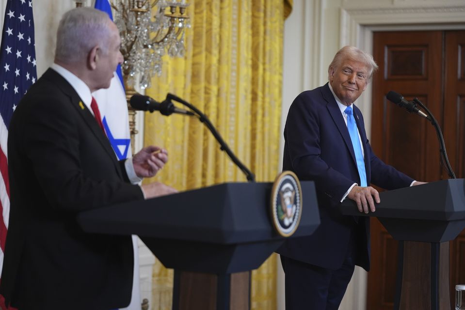 US President Donald Trump listens as Israel’s Prime Minister Benjamin Netanyahu speaks during a news conference in the East Room of the White House (Evan Vucci/AP)