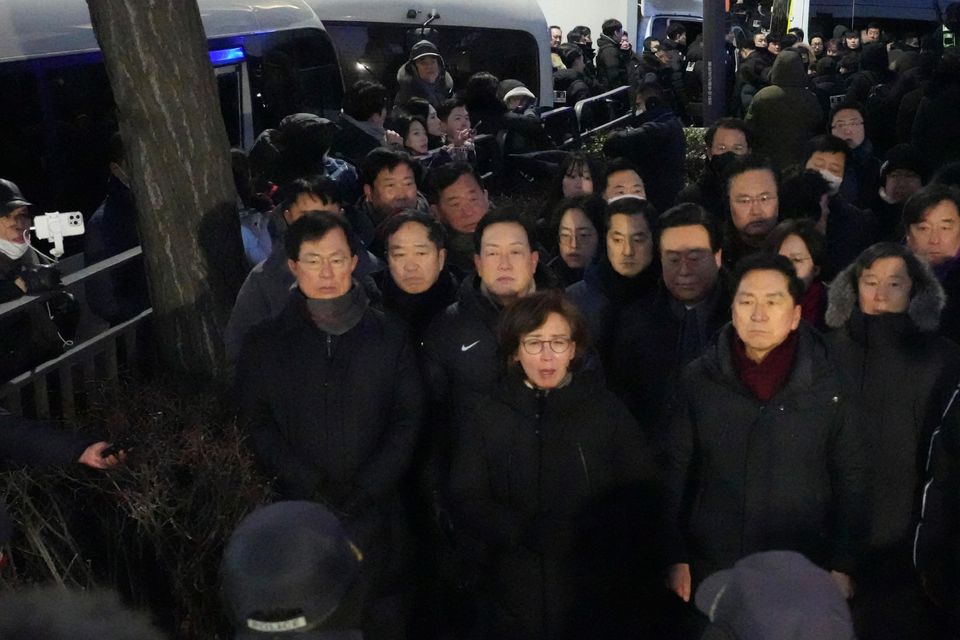 Politicians from the ruling People Power Party speak to media outside of the gate of the presidential residence in Seoul (Lee Jin-man/AP)