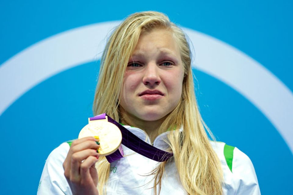 LONDON, ENGLAND - JULY 30:  Ruta Meilutyte of Lithuania reacts as she receives her gold medal during the medal ceremony for the Women's 100m Breaststroke on Day 3 of the London 2012 Olympic Games at the Aquatics Centre on July 30, 2012 in London, England.  (Photo by Adam Pretty/Getty Images)
