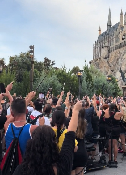 Harry Potter fans raised their wands outside the Hogwarts Castle replica in Florida in a tribute to Dame Maggie Smith (Geraint Walker/PA)