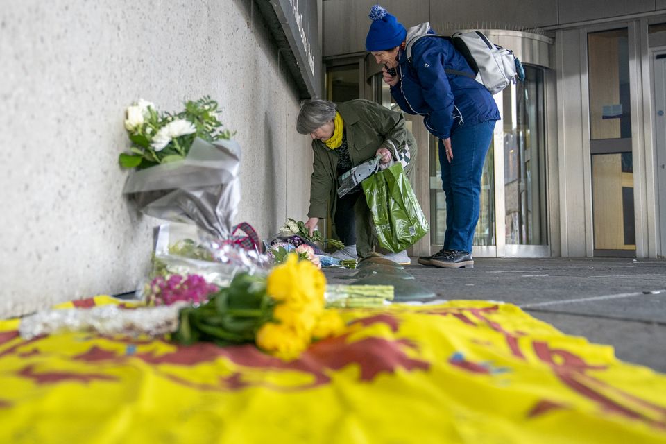 Members of the public left floral tributes outside the Scottish Parliament in Edinburgh after news of Mr Salmond’s death (Jane Barlow/PA)