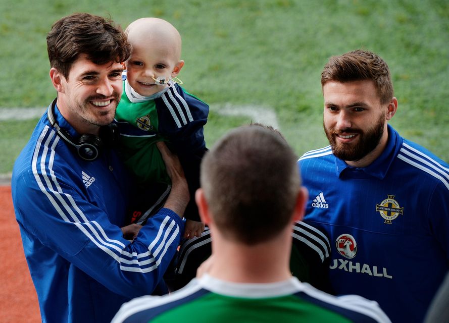 BELFAST, NORTHERN IRELAND - MAY 27: Northern Ireland's Kyle Lafferty (L) and Stuart Dallas (R) pose with fans before the international friendly game between Northern Ireland and Belarus on May 26, 2016 in Belfast, Northern Ireland. (Photo by Charles McQuillan/Getty Images)