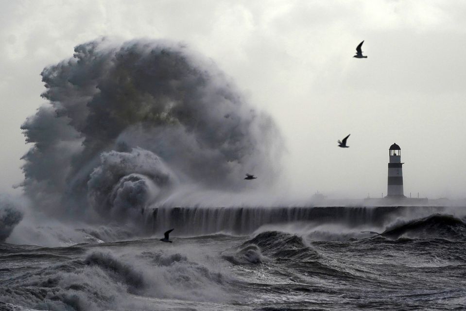 Waves crash against the lighthouse in Seaham Harbour, County Durham (Owen Humphreys/PA)