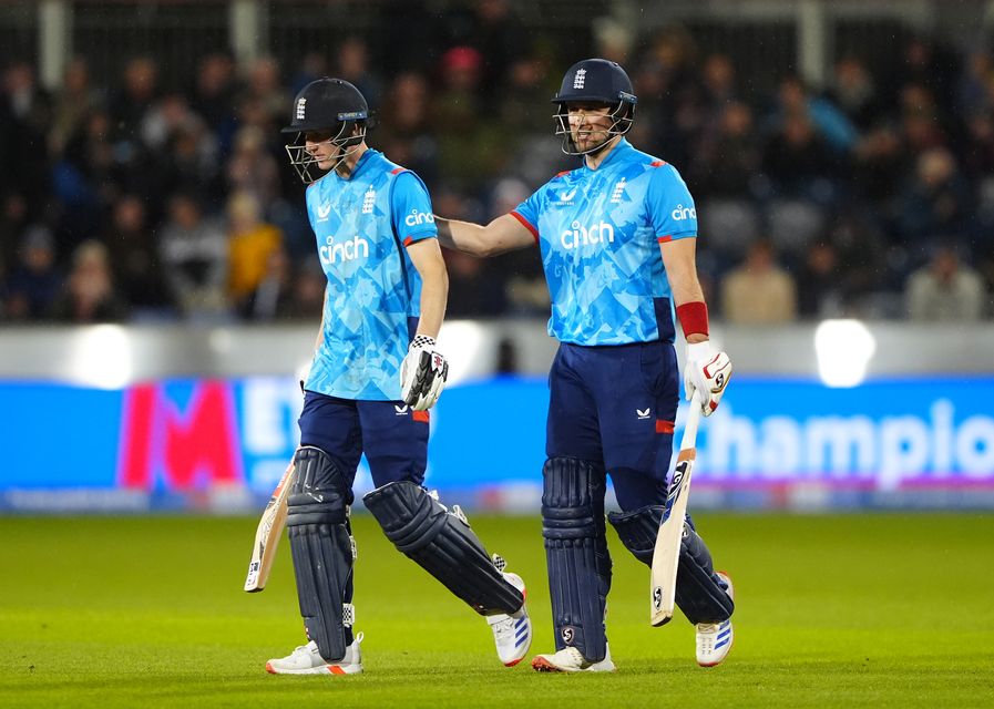 Harry Brook, left, is patted on the back by Liam Livingstone as England’s batters leave the pitch for rain (Owen Humphreys/PA)