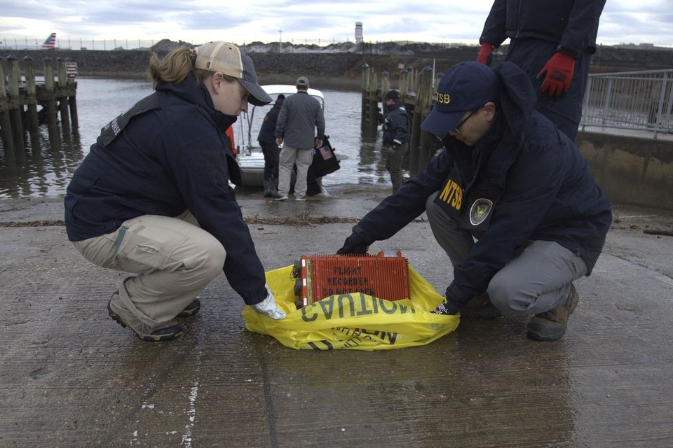 Investigators examine a flight data recorder recovered from the Potomac (NTSB/AP)