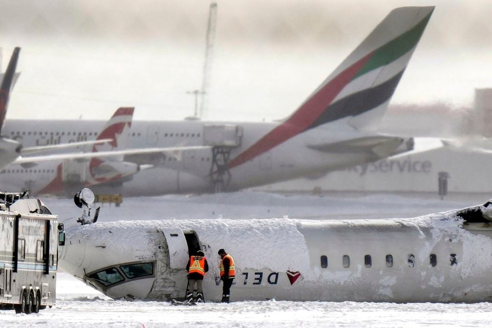 Passengers described crashing into the ceiling after undoing their seat belts and escaping the plane (Chris Young/The Canadian Press via AP)