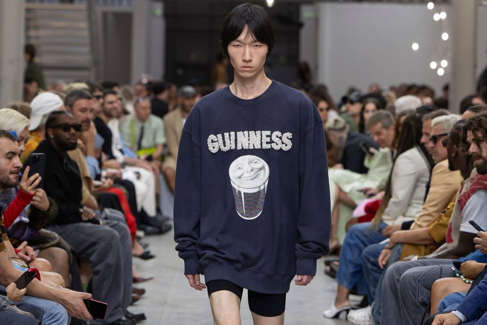 To launch a creative partnership with Guinness, Jonathan Anderson sends a model down the catwalk at Milan Fashion Week in a jersey pearl-style sweatshirt, mixing elements of unexpected luxury and grounding them in familiar iconography. 