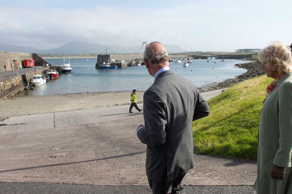 Britain's Prince Charles, Prince of Wales (L) and his wife Camilla, Duchess of Cornwall (R) visit the harbour in the village of Mullaghmore in Ireland on May 20, 2015 where the prince's great-uncle Lord Mountbatten was killed in an IRA explosion in 1979. Britain's Prince Charles spoke of his "anguish" at the murder of his godfather by IRA paramilitaries in 1979 as he became the first royal to visit the assassination site in Ireland.  Charles remembered Lord Louis Mountbatten as "the grandfather I never had" on an emotional trip to the rugged coastline, saying he understood the suffering of the Irish people in "a profound way".  Peter McHugh helped with the rescue effort in the aftermath of the 1979 attack.  AFP PHOTO / POOL / ARTHUR EDWARDSARTHUR EDWARDS/AFP/Getty Images