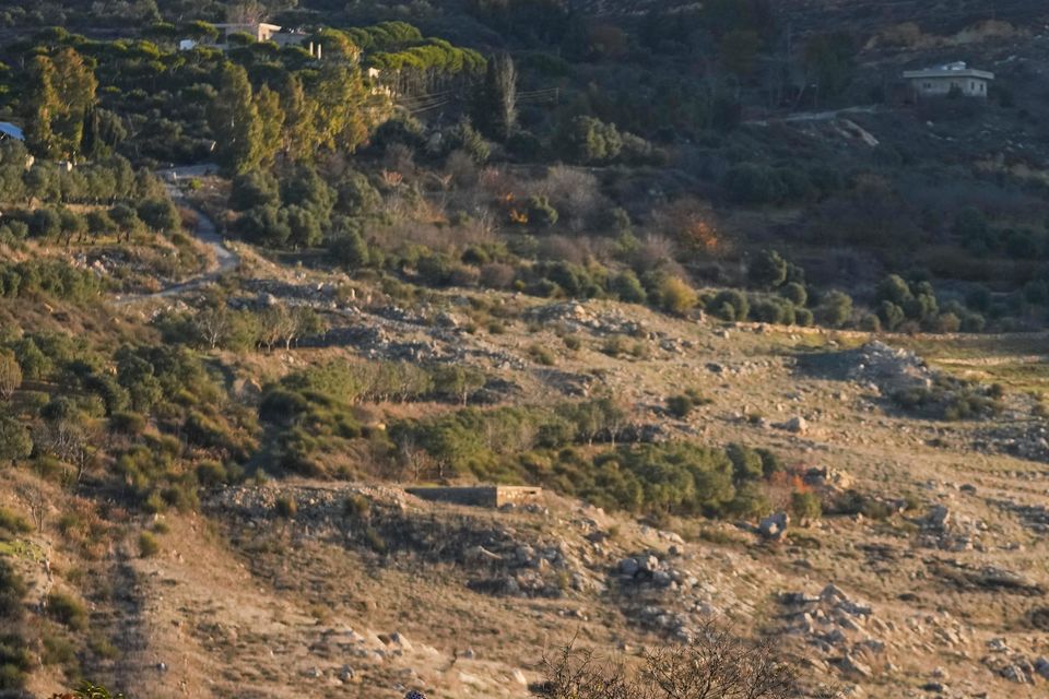 An Israeli soldier stands guard at a security fence near the so-called Alpha Line that separates the Israeli-annexed Golan Heights from Syria (Matias Delacroix/AP)