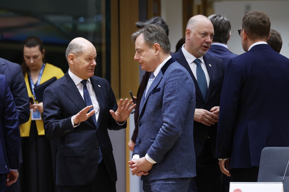 Germany’s Chancellor Olaf Scholz, centre left, speaks to Belgium’s Prime Minister Bart De Wever during a round table meeting at the EU Summit in Brussels (Geert Vanden Wijngaert/AP)