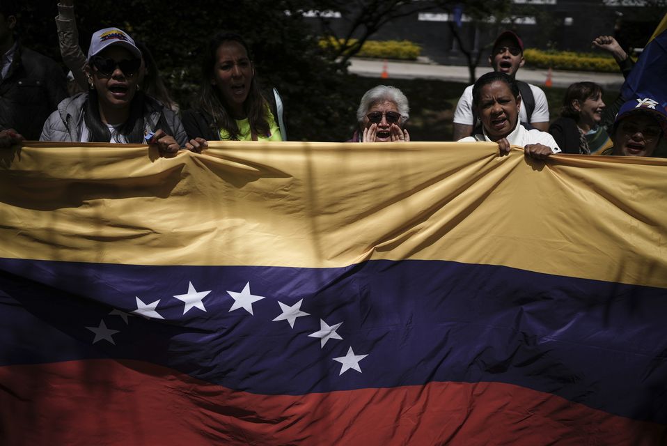 Demonstrators in Bogota, Colombia, protesting against the contested presidential election results in Venezuela (AP Photo/Ivan Valencia)