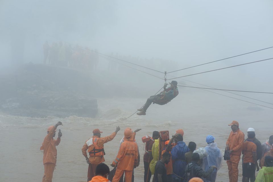 Rescuers try to reach affected people after landslides hit hilly villages in Wayanad district (AP Photo)