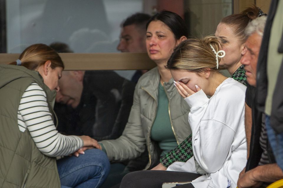 A woman cries outside a hospital in the town of Kocani, North Macedonia following a massive fire in a nightclub early on Sunday (AP/Visar Kryeziu)