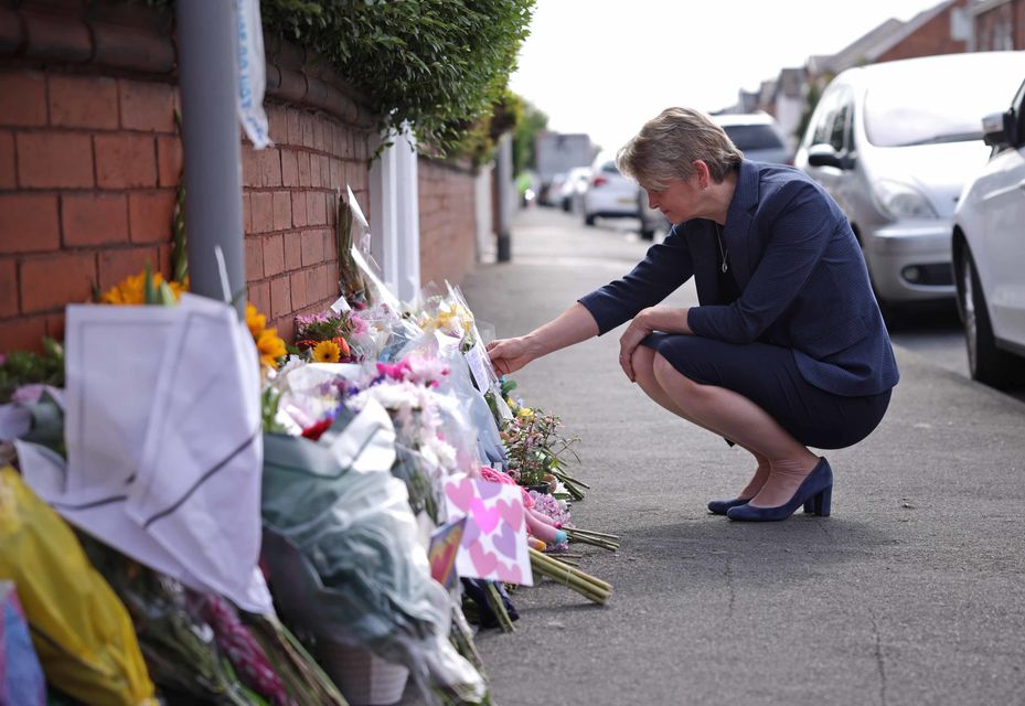 Home Secretary Yvette Cooper reads messages left on flowers near the scene (James Speakman/PA)