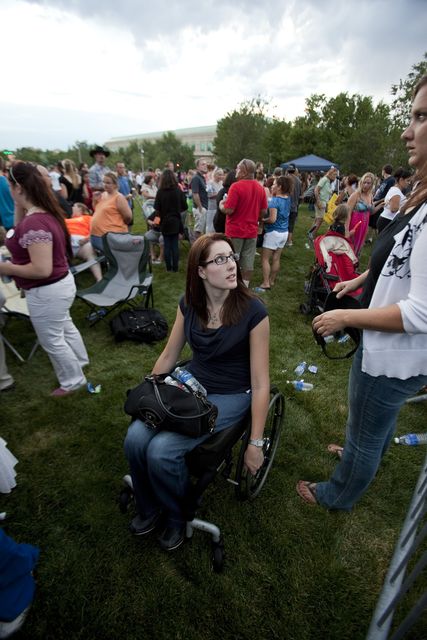 Anne Marie Hochhalter, centre, attends a vigil for the victims of the Aurora cinema shooting in 2012 (Barry Gutierrez/AP)