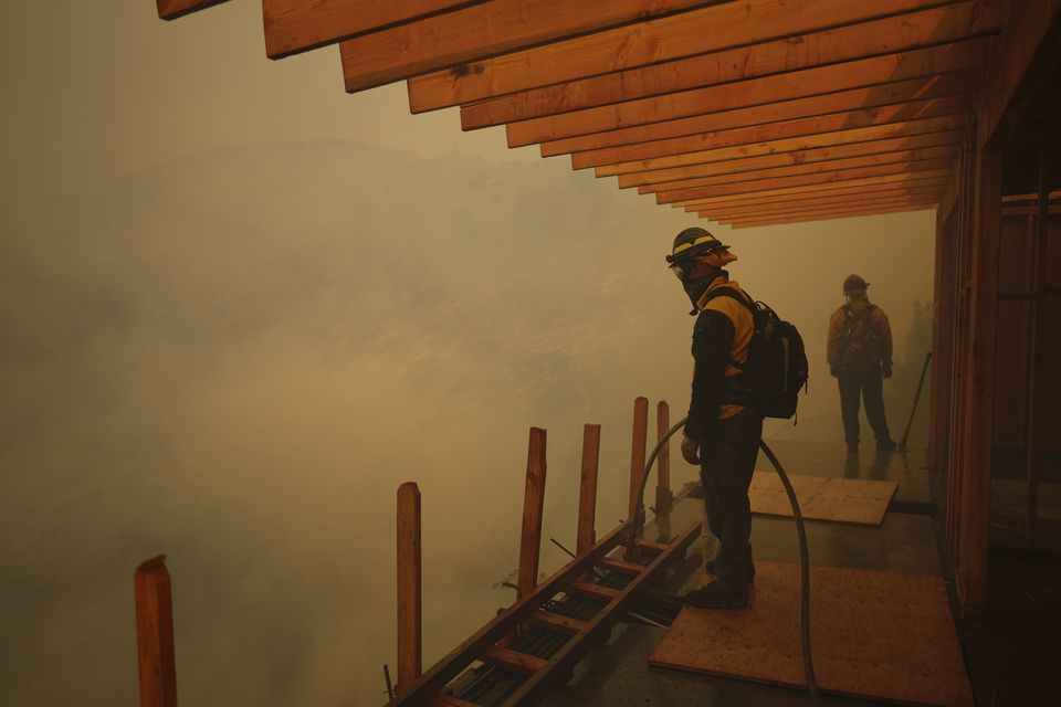 Firefighters monitor the advance of the Palisades Fire in Mandeville Canyon (Eric Thayer/AP)