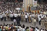 thumbnail: Citizens and police officers walk during the funeral procession of Hemant Karkare, the chief of Mumbai's Anti-Terrorist Squad, who was killed by gunmen, his photo seen at right top, in Mumbai, India, Saturday, Nov. 29, 2008. Indian commandos killed the last remaining gunmen holed up at a luxury Mumbai hotel Saturday, ending a 60-hour rampage through India's financial capital by suspected Islamic militants that killed people and rocked the nation. (AP Photo/Rajanish Kakade)