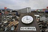 thumbnail: A clock that appears to indicate the time when a tsunami struck lies among the rubble in the city of Kesennuma, northeastern Japan, on Tuesday March 15, 2011. The Japanese characters read: "40th Anniversary of Foundation."