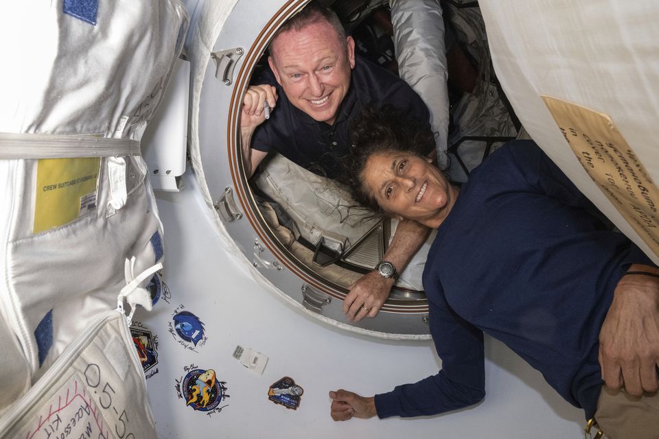 Butch Wilmore, left, and Suni Williams pose for a portrait inside the vestibule between the forward port on the International Space Station’s Harmony module and Boeing’s Starliner spacecraft (Nasa via AP)