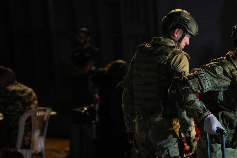 Turkish military personnel carry luggage of Turkish citizens to be evacuated on Turkish military ships from Lebanon to Turkey, in Beirut port (Emrah Gurel/AP)