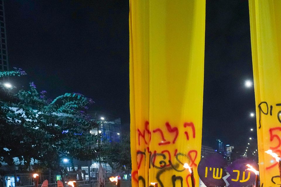 Relatives and supporters of Israelis held hostage by Hamas in Gaza light torches during a rally marking 500 days of captivity (AP Photo/Ariel Schalit)