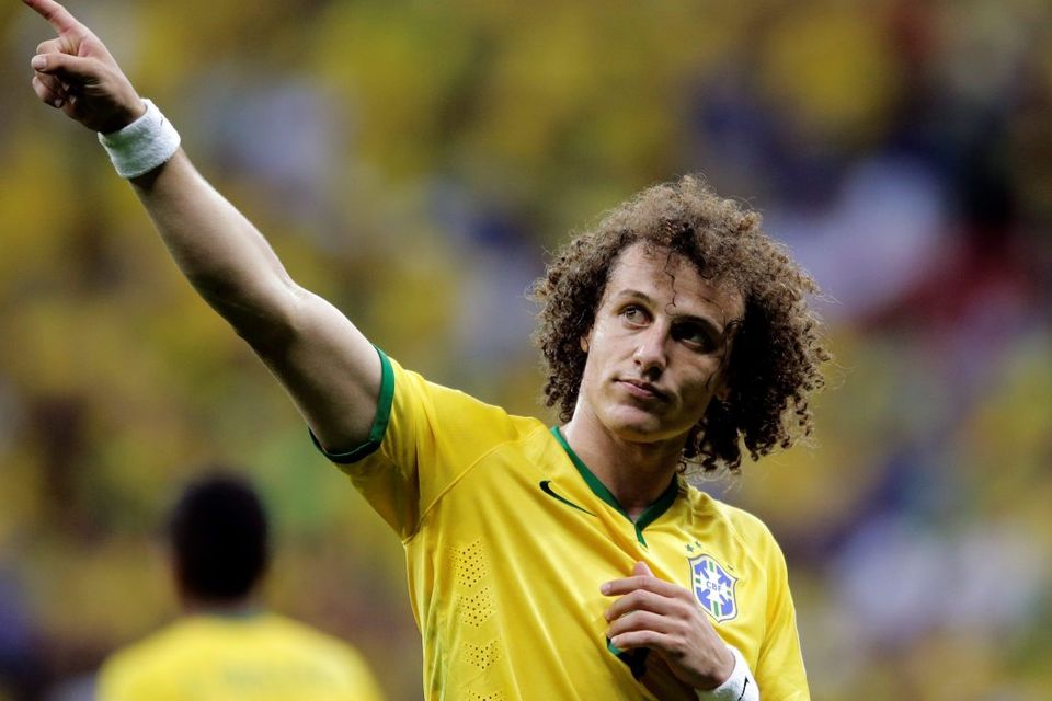 Brazil's David Luiz points to spectators following Brazil's 4-1 victory over Cameroon in the group A World Cup soccer match between Cameroon and Brazil at the Estadio Nacional in Brasilia, Brazil, Monday, June 23, 2014. (AP Photo/Bernat Armangue)