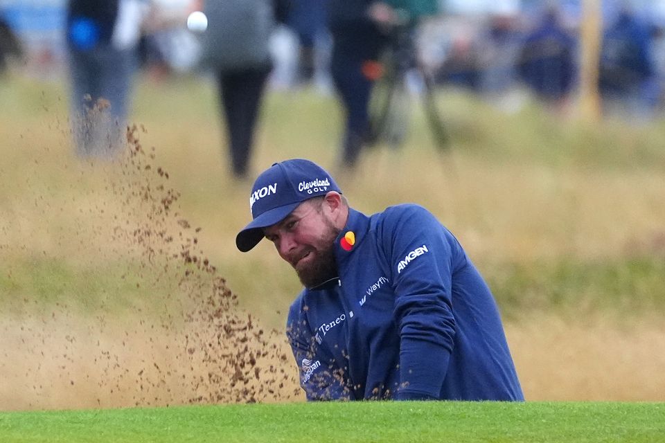 Shane Lowry chips out of a bunker on the 16th during day one of The Open at Royal Troon (Owen Humphreys/PA)