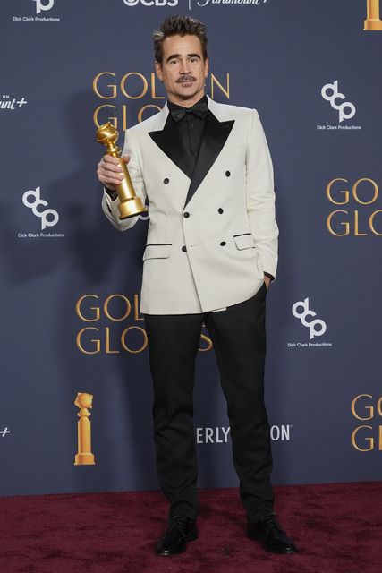 Colin Farrell poses in the press room with his award (Chris Pizzello/AP)