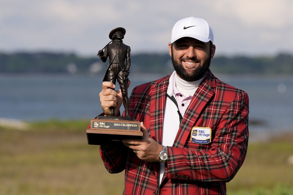 Scottie Scheffler holds the trophy after winning the weather delayed RBC Heritage (Chris Carlson/AP)