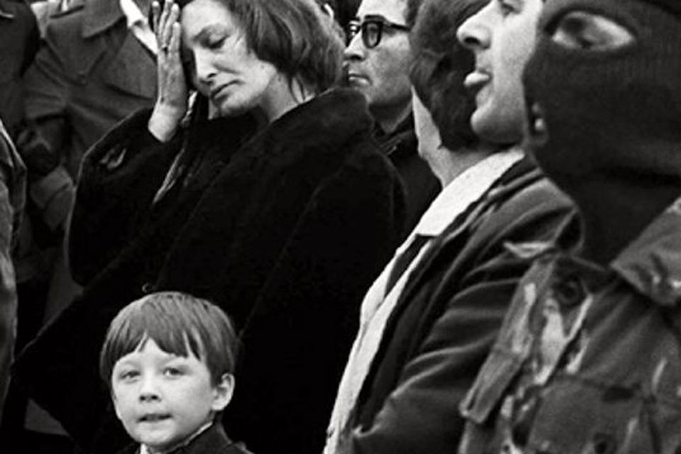 Bobby Sands' son Robert Gerald holds his mother's hand at the funeral of his father Bobby in west Belfast flanked by Masked IRA men. Picture by Martin Wright