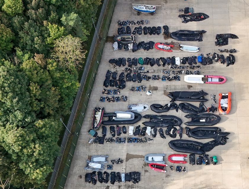 Small boats and outboard motors used by people thought to be migrants to cross the Channel in storage at a warehouse facility in Dover, Kent (Gareth Fuller/PA)