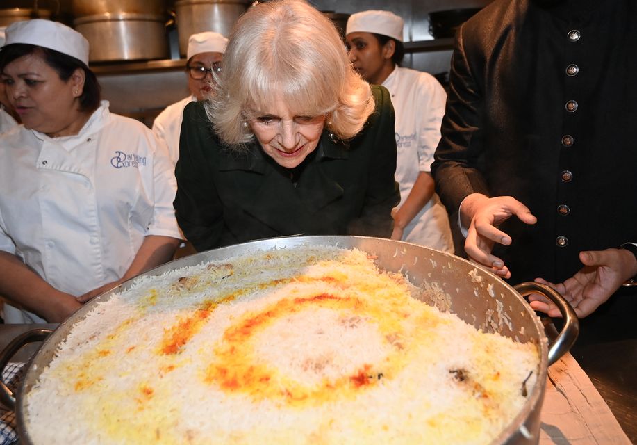 Camilla takes a close look at the basmati rice (Eddie Mulholland/Daily Telegraph/PA)