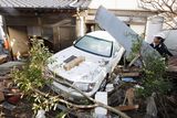 thumbnail: A resident of the seaside town of Yotsukura, northern Japan, clears debris from his home Monday, March 14, 2011, three days after a giant quake and tsunami struck the country's northeastern coast. (AP Photo/Mark Baker)