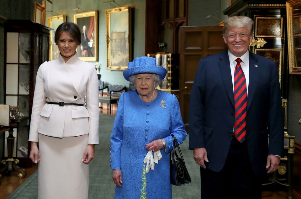 US President Donald Trump beams as he and and his wife, Melania, prepare to join the Queen for tea at Windsor (Steve Parsons/PA)