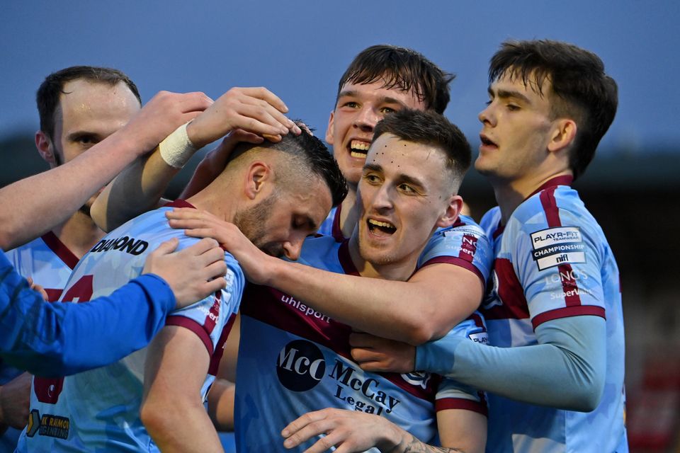 Daniel Lafferty is crowded by Institute team-mates after netting in the Promotion/Relegation Play-Off