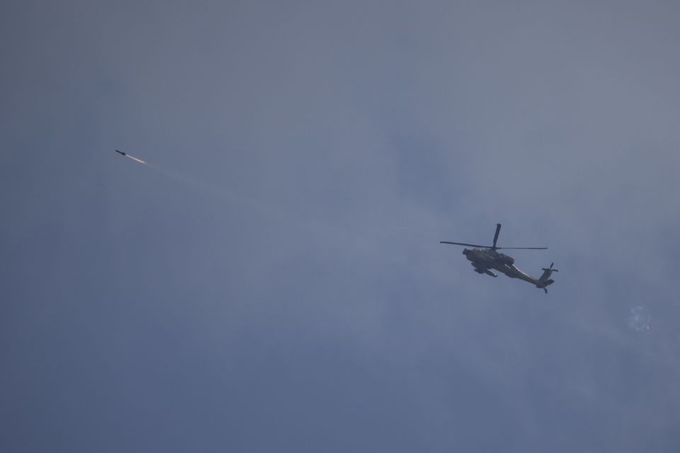 An Israeli Apache helicopter fires a missile towards southern Lebanon (Leo Correa/AP)