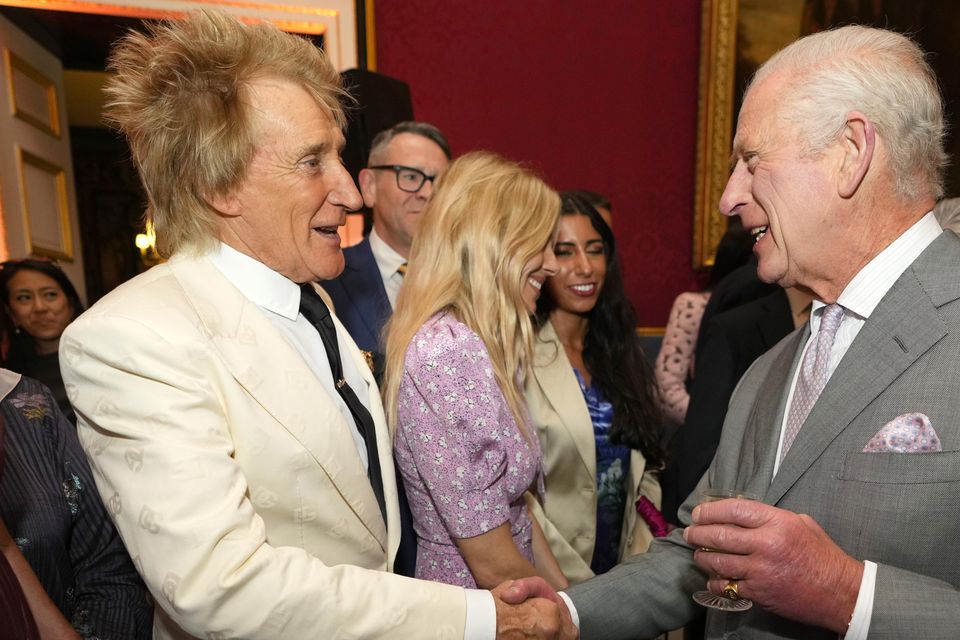 The King shakes hands with Rod Stewart (PA)