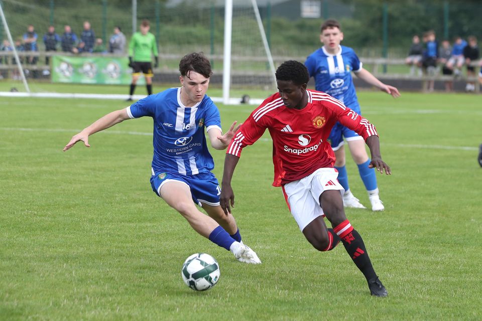 Manchester United’s Douka Nkoto Abdoulaye with Callum St Ledger of Co Fermanagh at the Riada