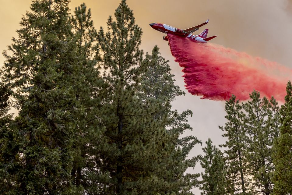 A firefighting plane releases retardant (Stephen Lam/San Francisco Chronicle/AP)