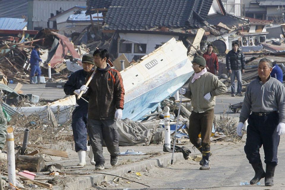 Residents head to search for missing people in Yamada, northern Japan Monday, March 14, 2011 following Friday's massive earthquake and the ensuing tsunami. (AP Photo/Kyodo News)  JAPAN OUT, MANDATORY CREDIT, NO SALES IN CHINA, HONG  KONG, JAPAN, SOUTH KOREA AND FRANCE