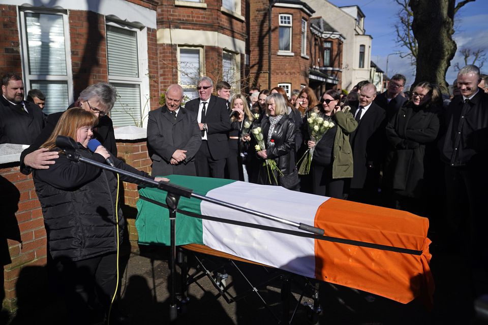 Brendan ‘Bik’ McFarlane’s wife Lene and daughter Tina speaking next to his coffin before it leaves his family home on Cliftonville Road, Belfast (Niall Carson/PA)