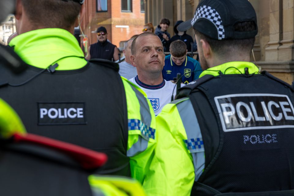 Roger Haywood stands in front of police (Michael Holmes/PA)